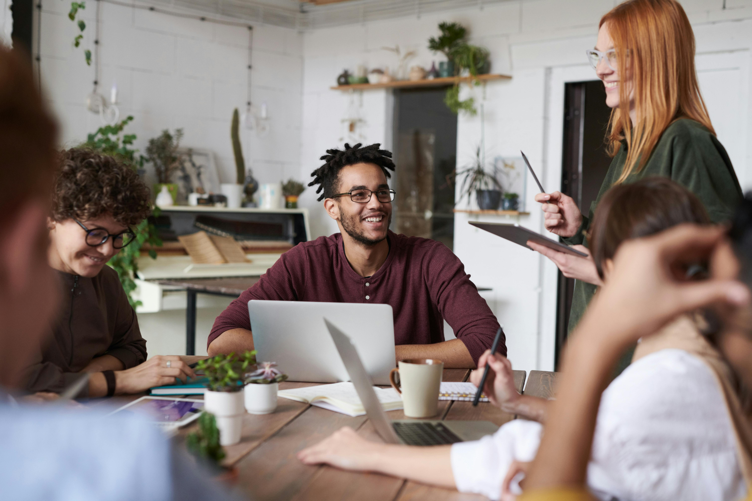 work team talking and smiling at a meeting