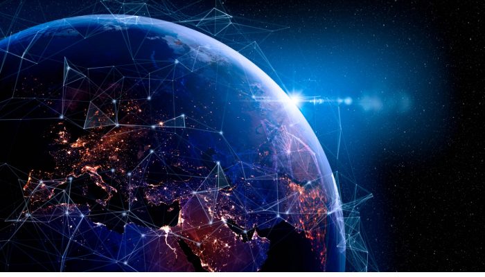 close-up artificial image of earth with glowing blue network connection lines